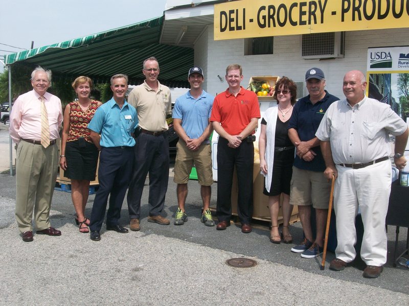 State and local organizations celebrate the expansion of Shore Gourmet into Delaware at Fifer's Orchards Market in Dewey Beach.Shown are (l-r) Bob Stickels, representative for Congressman John Carney; Karen McGrath, representative for Sen. Tom Carper; Jack Tarburton, USDA rural development state director; Austin Short, deputy secretary of Delaware Department of Agriculture; Brandon Smith, Fifer Orchards Market manager; Scott Warner, executive director of Mid-Shore Regional Council; Terry Deighan, office manager at Mid-Shore Regional Council; Kevin Deighan, general manager of Shore Gourmet; and Brad Powers, president of Shore Gourmet Board of Directors. BY KARA NUZBACK